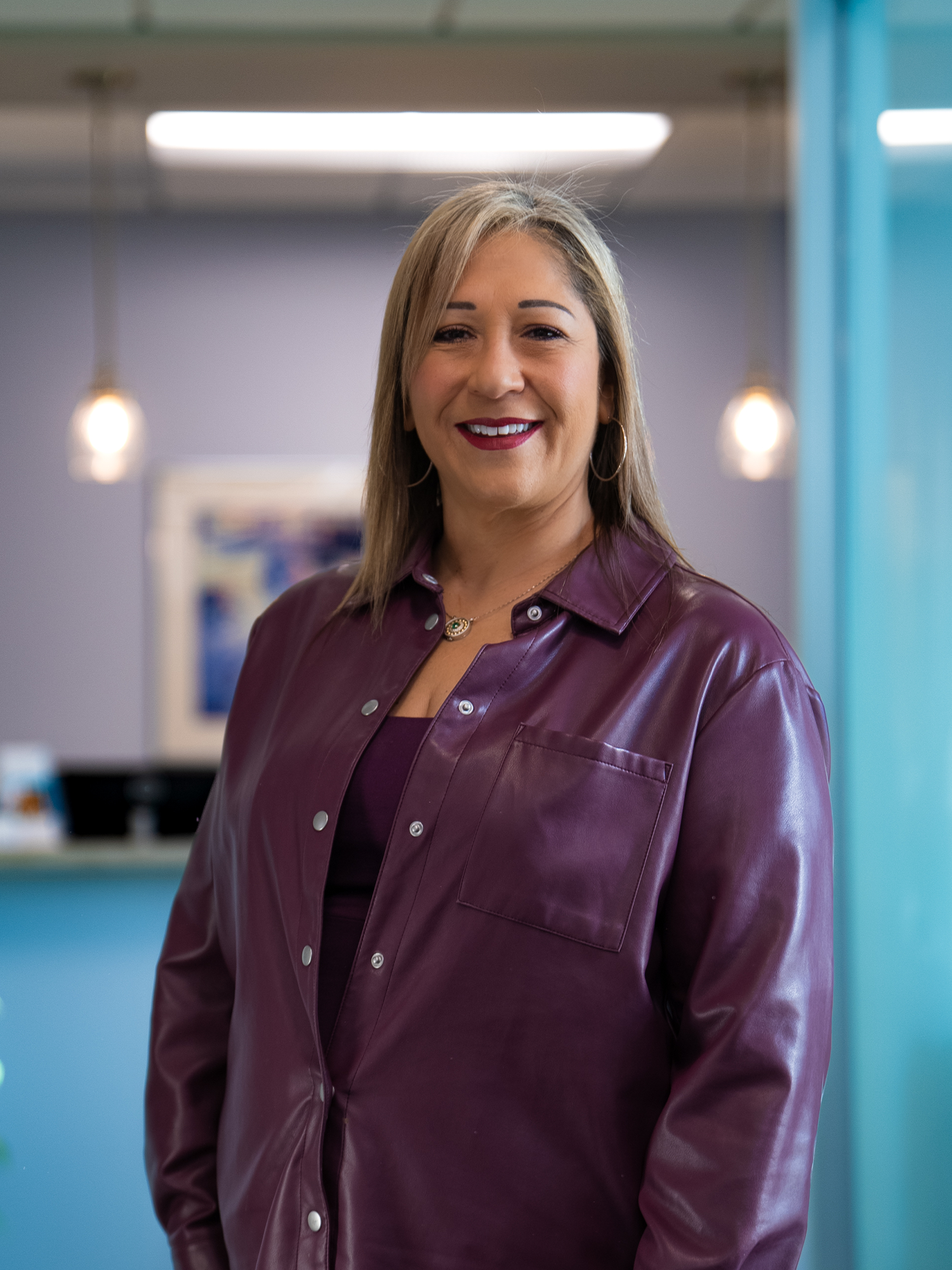patient smiling in hallway of office